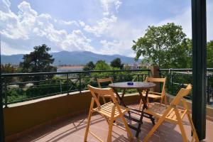 a patio with a table and chairs on a balcony at Hotel Fani in Leptokarya