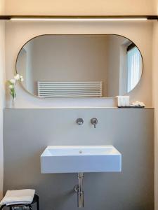 a bathroom with a white sink and a mirror at Villa Verlengia in Montesilvano