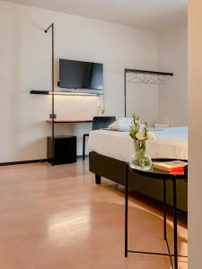 a bedroom with a bed and a table and a tv at Villa Verlengia in Montesilvano