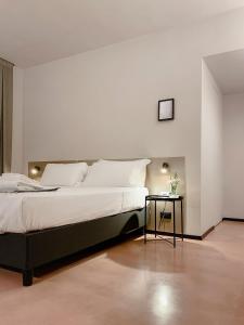 a bedroom with a large bed and a side table at Villa Verlengia in Montesilvano