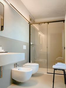 a bathroom with a toilet and a sink and a shower at Villa Verlengia in Montesilvano