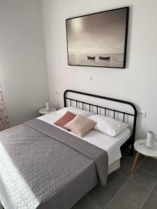 a bedroom with a bed with a picture on the wall at Apartment Olea in Marina +47 photos
