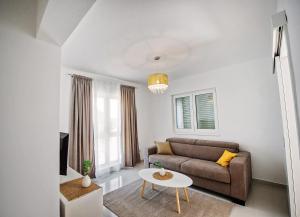 a living room with a couch and a table at Sea Front Apartments Ivana in Rogoznica