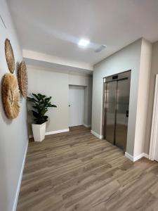 an empty hallway with a door and a potted plant at Hostal Eden in Sanxenxo