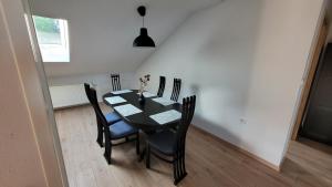 a dining room with a black table and chairs at Apartma Krupa in Gradac