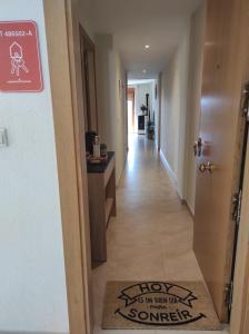 a hallway with a door with a sign that says holy to wear out something at Apartamento La Coveta de Guadalest in Guadalest
