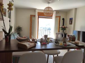 a table with food on it in a room with a window at Apartamento La Coveta de Guadalest in Guadalest