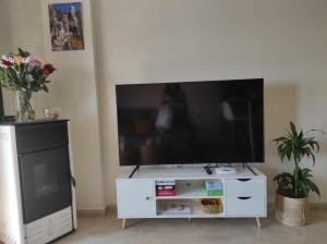 a white entertainment center with a flat screen tv at Apartamento La Coveta de Guadalest in Guadalest