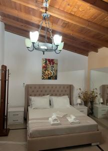 a bedroom with a large bed with a wooden ceiling at Biraci Residence in Ksamil +20 photos