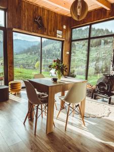 a dining room with a table and chairs with a view at Panoramic Noah's Loft in Stînceni