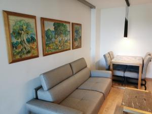 a living room with a couch and a table at DOM LORON in Poreč