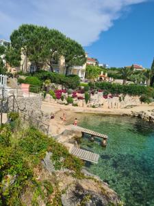 a pool of water with people on a beach at Villa Carpe Diem in Vantačići
