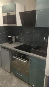 kuchnia z płytą kuchenną i zlewem w obiekcie Studette avec SPA & Jacuzzi w mieście Sète