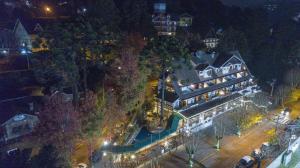 an aerial view of a large building with lights at Le Suisse Elegance Hotel in Campos do Jordão