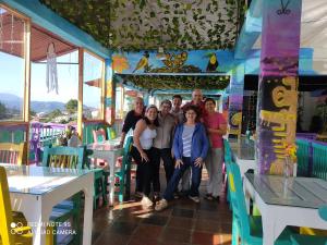 a group of people posing for a picture on a carousel at El Patio de mi Casa Hotel Restaurante in Salento