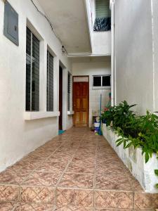 a hallway of a house with a red door at Hostal Inn 1 in Flores