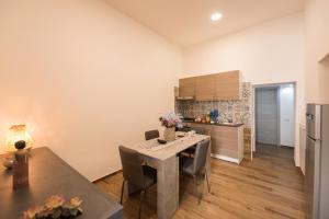 a kitchen with a table and chairs in a room at Dimora Francesca in Salerno