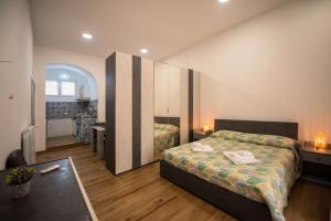 a hotel room with a bed and a desk at Dimora Francesca in Salerno +16 photos