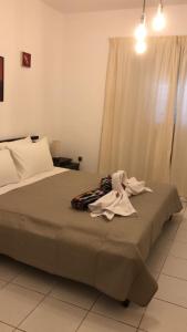 a bedroom with a bed with clothes on it at Town House, Ilios II, Kato Paphos in Paphos City