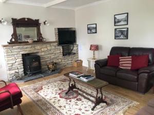 uma sala de estar com um sofá e uma lareira em Gortamullen House, Kenmare em Kenmare