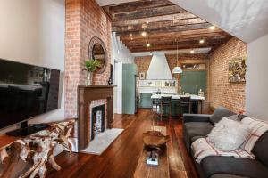 a living room with a couch and a fireplace at Historic Garden District 5BR with Parking and Balcony in New Orleans