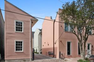um edifício rosa ao lado de uma casa rosa em Historic Garden District 5BR with Parking and Balcony em Nova Orleans