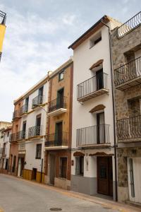 a row of apartment buildings on a street at Casa Monferrer in Useras