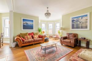 a living room with a couch and two chairs at Host & Stay - Cabbell Towers in Cromer +10 photos
