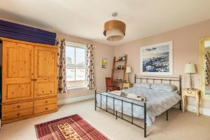 a bedroom with a bed and a large window at Host & Stay - Cabbell Towers in Cromer +9 photos
