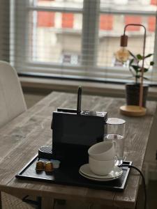 a table with a coffee maker and a cup on it at Maison Georges in Turnhout