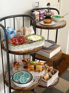 a three tiered plate rack with food on it at Eccelsoleccese Boutique B&B - steps from the Historic Center in Lecce