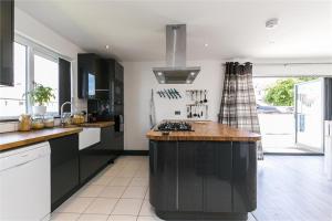 a kitchen with a large island in the middle at Dreghorn House 5 b-rooms 9 beds 3 toilets 2 showers,1 bath 2 receiption Secure free Parking 233 Wifi in Edinburgh