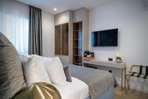 Televízia a/alebo spoločenská miestnosť v ubytovaní Amélie Luxury Rooms