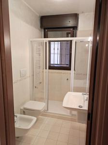 een badkamer met een douche, een toilet en een wastafel bij 6 a casa in Milaan