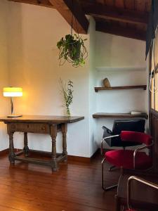 a room with a table and chairs and a lamp at Arcenoyu Rural inn in Villaviciosa