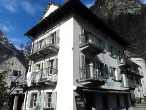 a white building with balconies on the side of it at Casa Eva in Brione