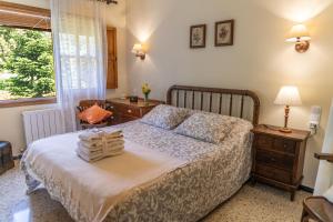 a bedroom with a bed and a desk and a window at Can Rosich in Santa Susanna