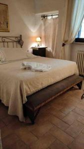 a hotel room with a bed and a mirror at Guesthouse da Idolina dal 1946 in Montalcino