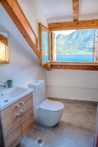 a bathroom with a toilet and a window at GuestHouse Mrshe Palace in Perast