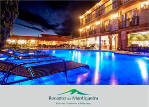 a large swimming pool in front of a building at Pousada Recanto da Mantiqueira in Passa Quatro