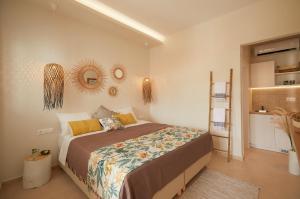 a bedroom with a bed and a mirror on the wall at Spiliada Boutique Studios in Batsi