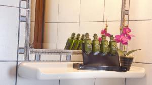 a bunch of bottles on a sink in a bathroom at House Chrysoula Mitsokopi in Sarti