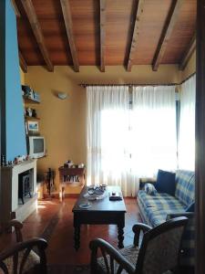 a living room with a couch and a coffee table at La casa azul de Lua Un lugar mágico in Juncedo-Campo