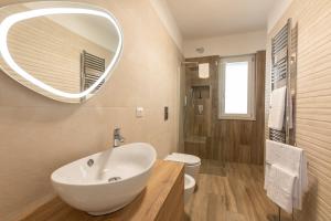 a bathroom with a white sink and a mirror at Appartamento L'Essenziale in Vieste