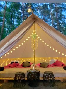 a tent with two beds with lights on it at Caravana Juliana - Glamping in Swaderki