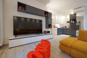 a living room with a large screen tv and a couch at Ghisello Luxury Guesthouse in Bologna