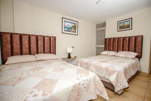 A bed or beds in a room at Antara Hostal