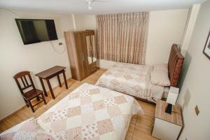 A bed or beds in a room at Antara Hostal