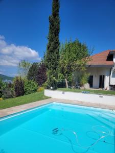 a swimming pool in front of a house at Beautiful property in front of Annecy Lake in Veyrier-du-Lac