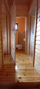 a wooden bathroom with a tub and a toilet at Domki Akwen in Rewal +16 photos
